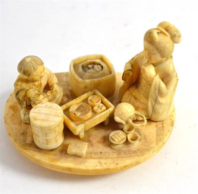 Lot 380 - Early 20th century carved ivory figural group of seated figures eating