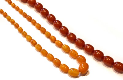 Lot 196 - An amber necklace, length 66cm; and an amber...