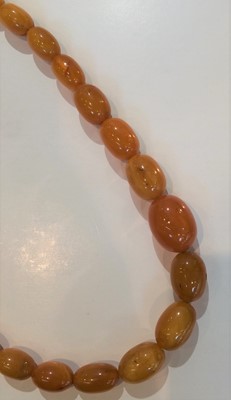 Lot 196 - An amber necklace, length 66cm; and an amber...