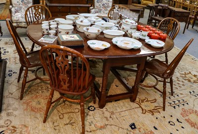 Lot 1089 - A 20th century crossbanded oak gateleg dining...