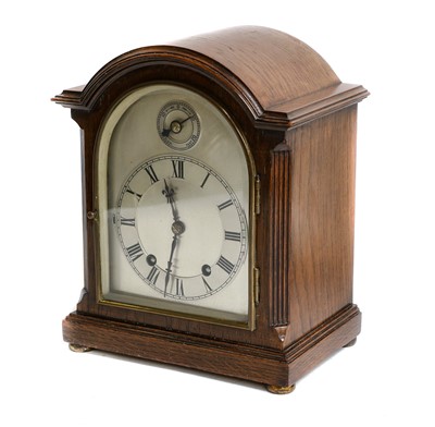 Lot 370 - An oak quarter striking mantel clock, movement...