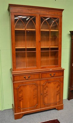 Lot 480 - Reproduction yew bookcase with glazed upper doors