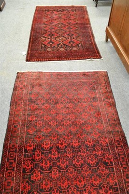 Lot 481 - Baloch rug, Persian/Afghan frontier, the honeycomb lattice field of hooked motifs enclosed by...