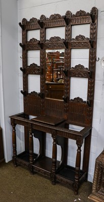 Lot 1196 - A Victorian carved oak hall stand, with...