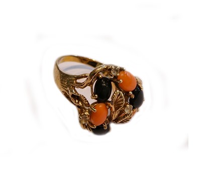 Lot 162 - An abstract coral and jet ring, stamped '14K',...