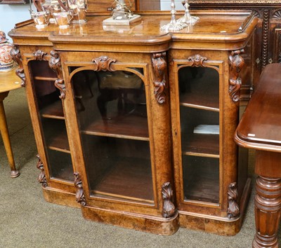 Lot 1270 - A Victorian figured walnut breakfront bookcase...