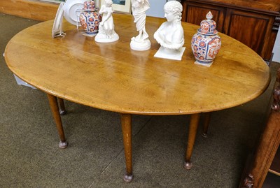 Lot 1269 - An early 20th century light oak wake table on...