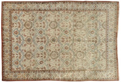 Lot 1077 - Ghom Carpet Central Persia The cream field with an allover lattice design of palmettes and...