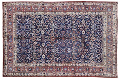 Lot 1078 - Veramin Carpet Central Persia The mid indigo field with an allover design of scrolling leafy...