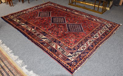 Lot 1115 - A Kashgai rug, the claret field with numerous...