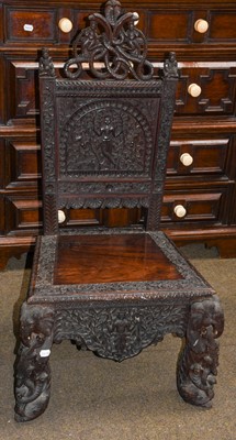 Lot 1276 - An Anglo-Indian ornately carved chair, the...