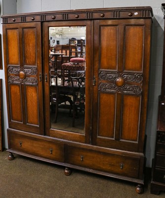 Lot 1201 - An early 20th century oak mirror fronted...