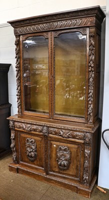 Lot 1316 - A Victorian heavily carved oak bookcase,...