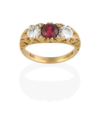 Lot 2317 - An 18 Carat Gold Synthetic Ruby and Diamond Three Stone Ring