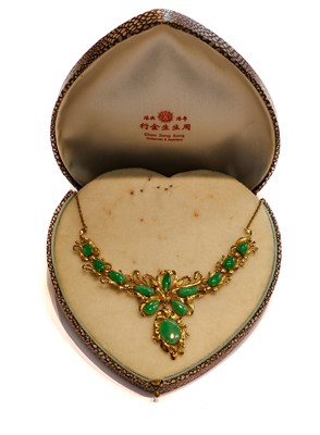 Lot 257 - A jade type necklace, stamped '14K', length 41....