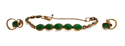 Lot 216 - A jade type bracelet, stamped '14K', length 16....