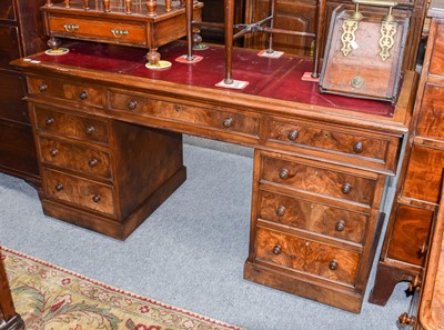 Lot 1231 - A Edwardian red leather inset walnut pedestal...