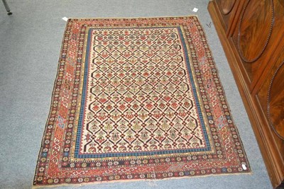 Lot 1087 - Daghestan Rug North East Caucasus The ivory honeycomb lattice field of stylised plants enclosed...