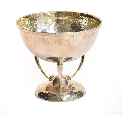 Lot 77 - A hammered silver bowl raised on three...