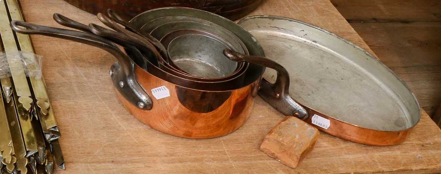 Lot 400 - A set of five graduated copper pans with iron...