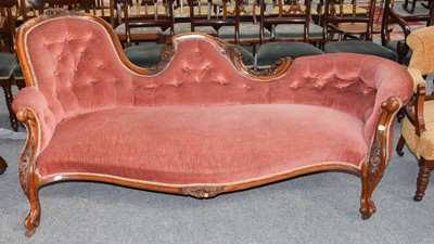 Lot 1212 - A Victorian spoon back settee in pink button...