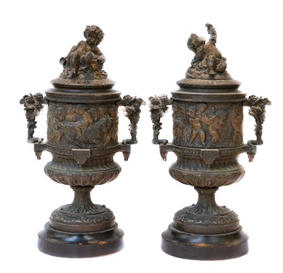 Lot 127 - A pair of patinated spelter urns and covers,...