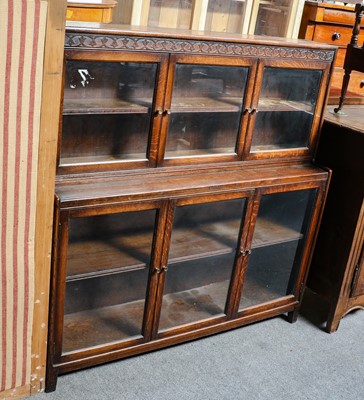 Lot 1242 - Two-piece stacking oak bookcase bearing paper...