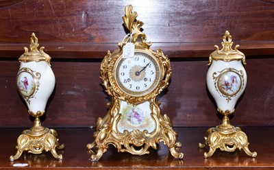 Lot 1184 - A gilt metal porcelain striking mantel clock...