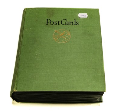 Lot 252 - An old green album containing approx. 233...