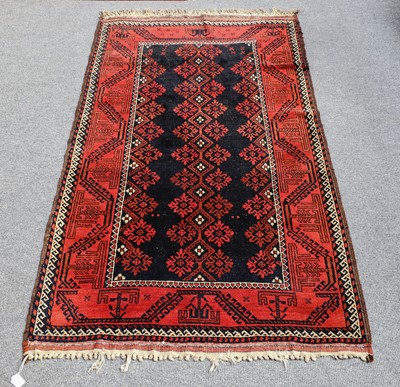Lot 1105 - A Baluch rug, the midnight blue field with...