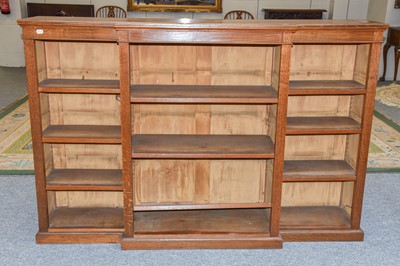 Lot 1173 - A 20th century oak breakfront bookcase, with...