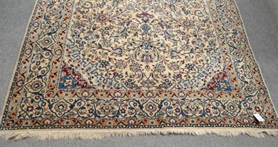 Lot 1094 - Nain Rug Central Persia The ivory field of scrolling and flowering vines around a sky blue...