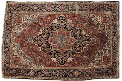 Lot 1096 - Heriz Carpet Persian Azerbaijan The terracotta field of angular vines centred by an indigo and...