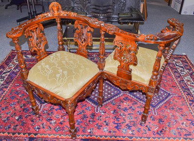 Lot 1136 - A reproduction carved conversation seat,...