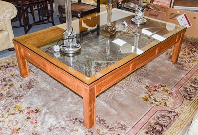 Lot 1126 - A modern oak glass topped coffee table, 150cm...