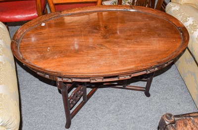 Lot 1129 - A Chinese oval tray top occasional table on a...