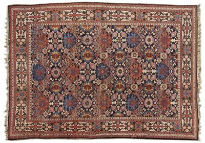 Lot 1097 - Unusual North West Persian Carpet The deep indigo field of large polychrome flowerheads and...