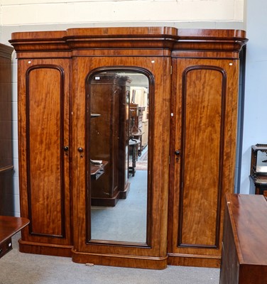 Lot 1069 - A large Victorian mirrored triple wardrobe,...