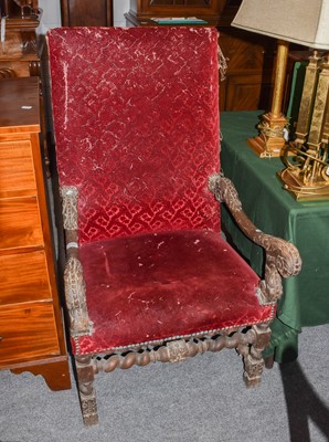 Lot 1199 - A Carolean style carved walnut open armchair...