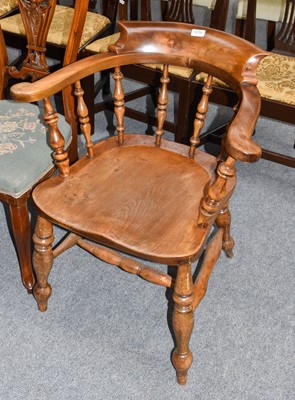 Lot 1216 - A 19th century elm Captain's chair