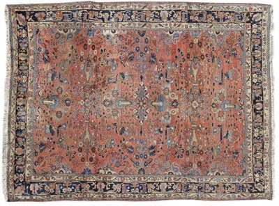 Lot 1099 - West Persian Carpet The coral field with columns of stylised vines enclosed by indigo borders...