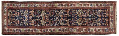 Lot 1100 - North West Persian Runner The deep indigo field of stylised birds and flowers enclosed by ivory...