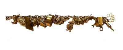Lot 179 - A charm bracelet, stamped '9CT', hung with...