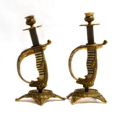 Lot 282 - A pair of bronze sword hilt candlesticks of...