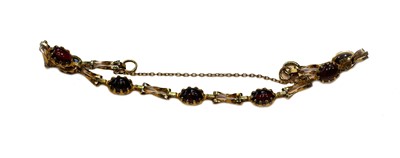 Lot 181 - A 9 carat gold garnet bracelet, length 19cm;...