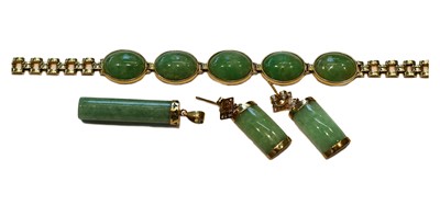 Lot 193 - A jade type bracelet, stamped '18K', length 18....