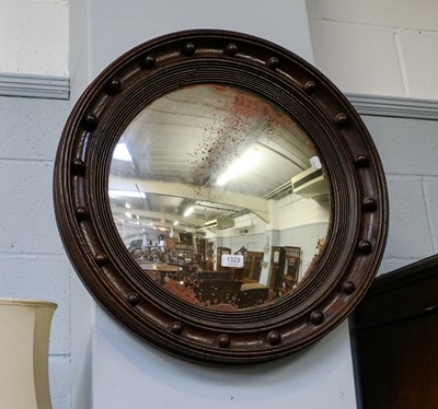 Lot 1323 - A Regency oak framed convex mirror, 63cm diameter