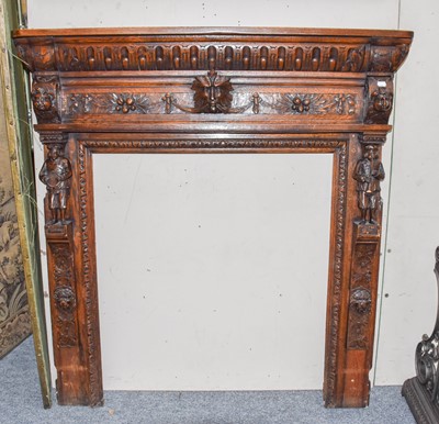 Lot 1257 - A carved oak fire surround decorated with...