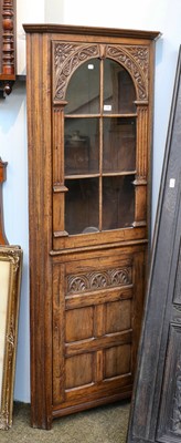 Lot 1390 - A 20th century carved oak standing corner...