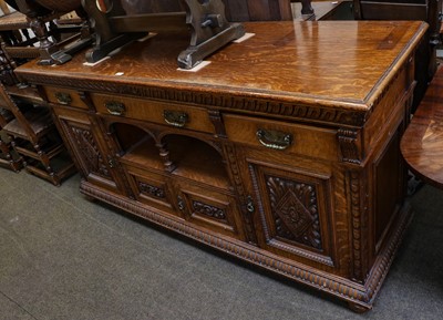 Lot 1387 - A late Victorian large carved oak sideboard...